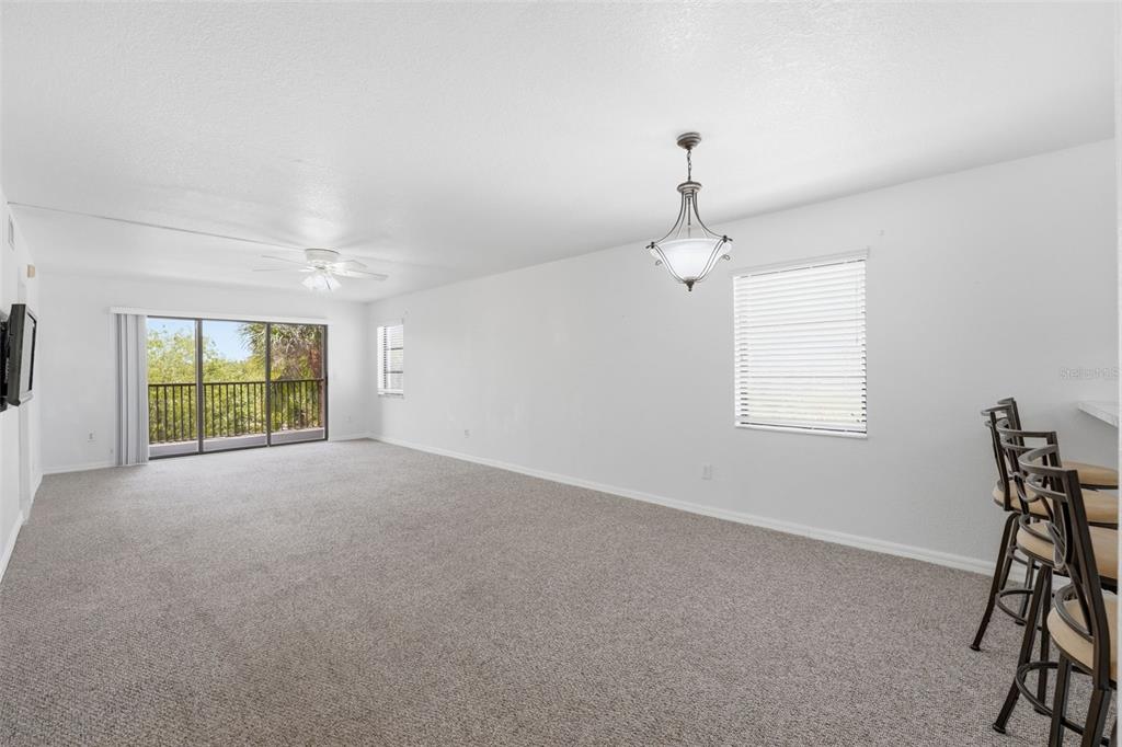 175 Kings Highway, Unit 328 Punta Gorda, FL 33983 - Photo 9 of 41 a furnished livingroom with windows and chandelier
