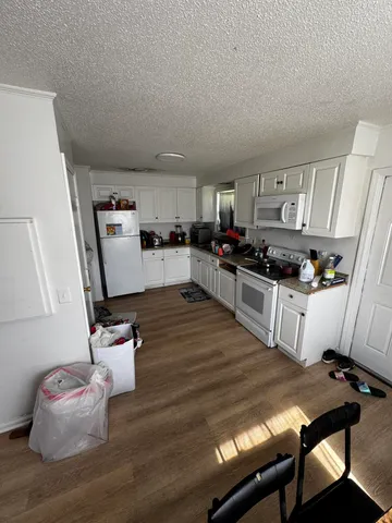 a kitchen with sink refrigerator and stove