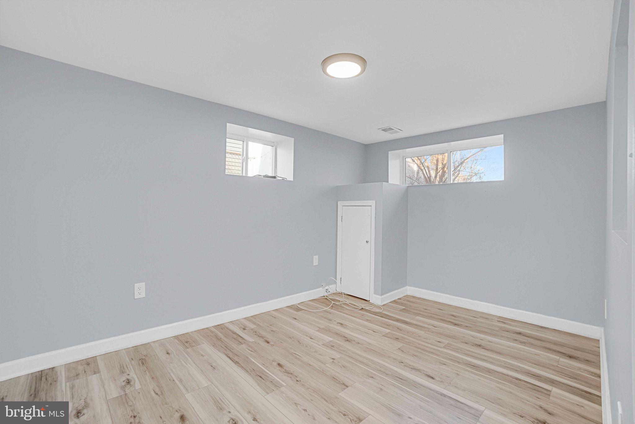 5922 Baltimore Street Baltimore, MD 21207 - Photo 26 of 33 a view of an empty room with wooden floor and a window