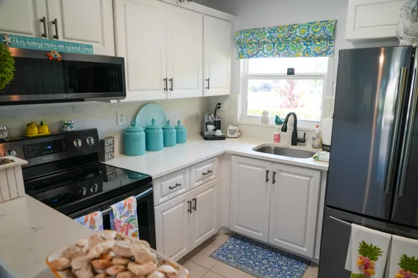 a kitchen with a sink stove and refrigerator