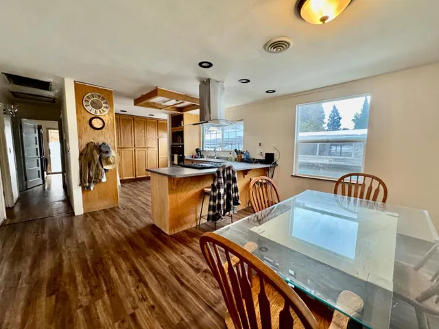 a dining room with furniture and wooden floor