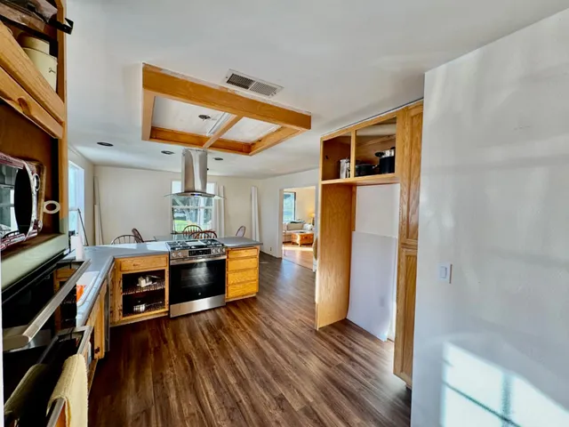 a view of a room with furniture and a chandelier