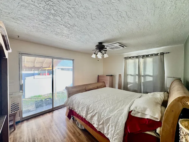 a bedroom with a large bed and a chandelier