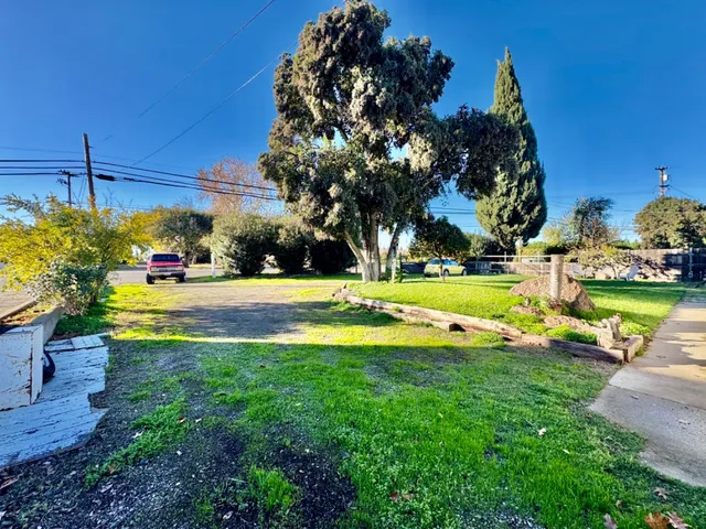a view of a house with swimming pool and yard