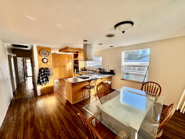 a living room with furniture or wooden floor and a flat screen tv
