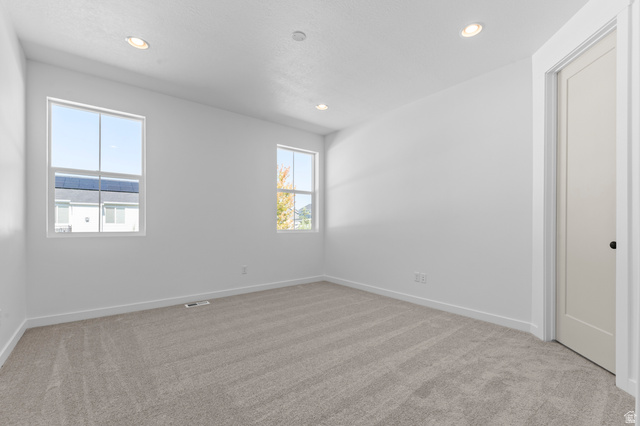 3016 West 2650 North Clinton, UT 84015 - Photo 17 of 20 Spare room with light carpet and recessed lighting