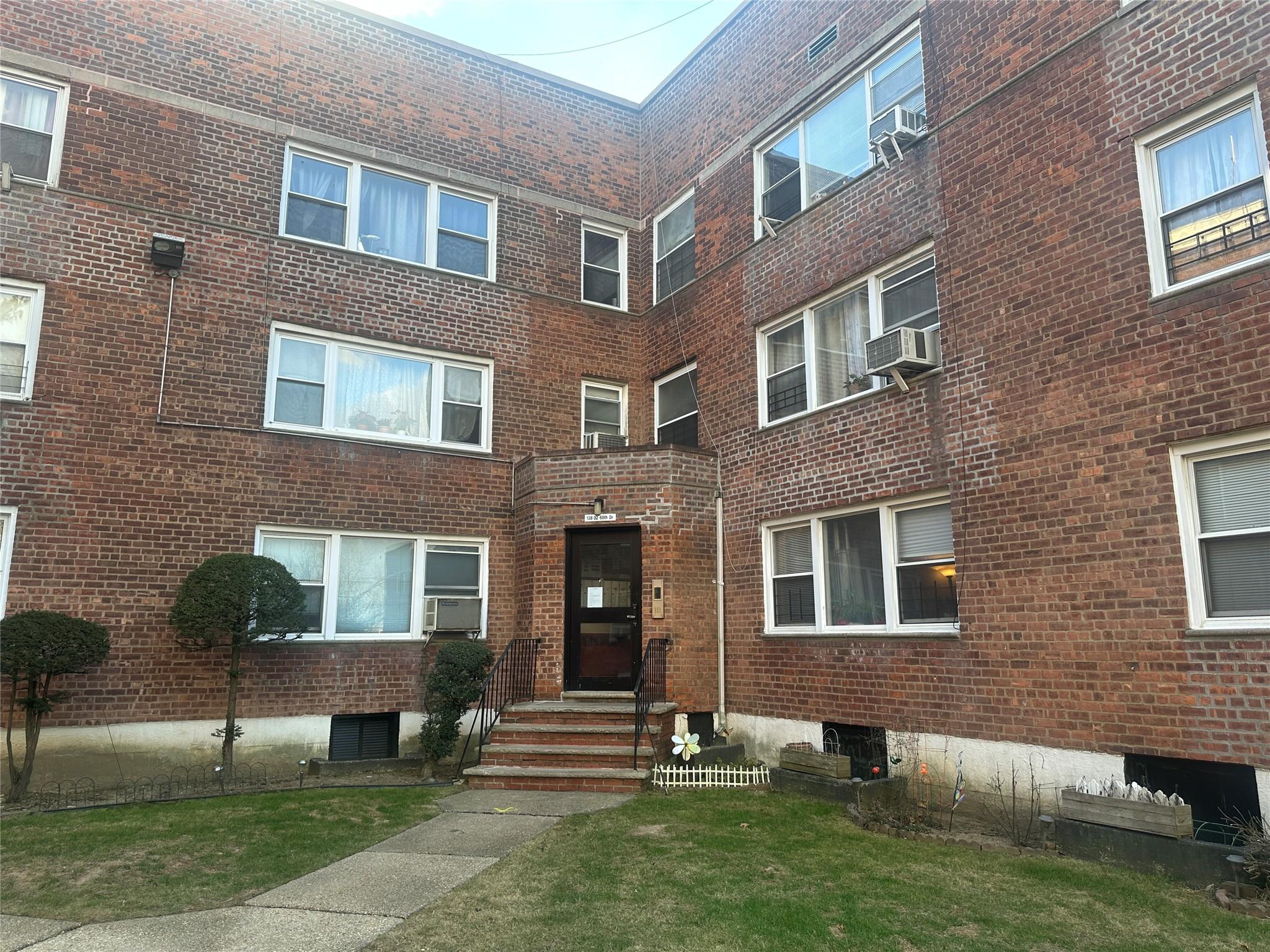 138-32 68th Drive, Unit 2B Queens, NY 11367 - Photo 1 of 10 a front view of a house with a yard