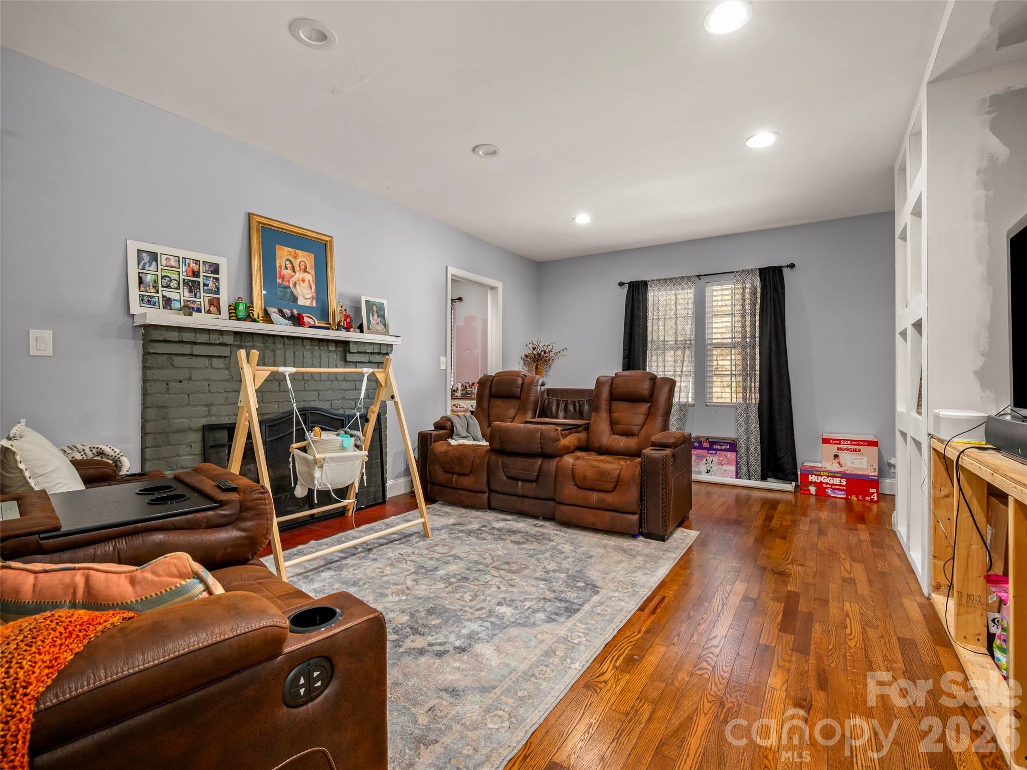 120 East Howard Street Tryon, NC 28782 - Photo 12 of 31 a living room with furniture a flat screen tv and a fireplace
