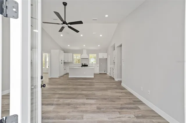 a view of a hallway with a kitchen