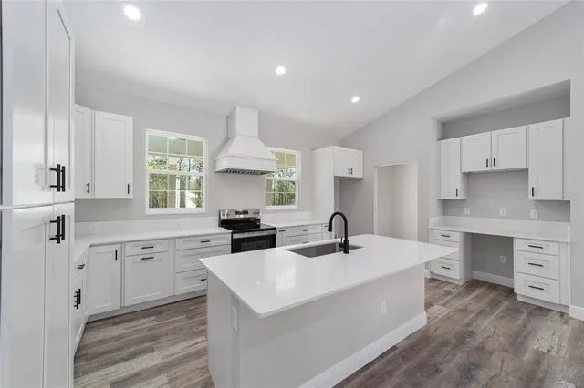 a kitchen with counter top space sink and cabinets