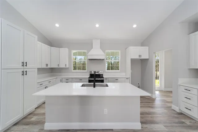 a kitchen with a stove a refrigerator and a sink