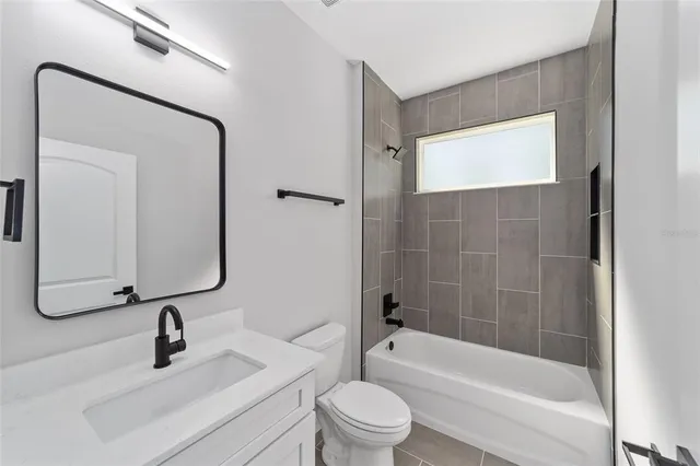 a bathroom with a sink a toilet and a bathtub