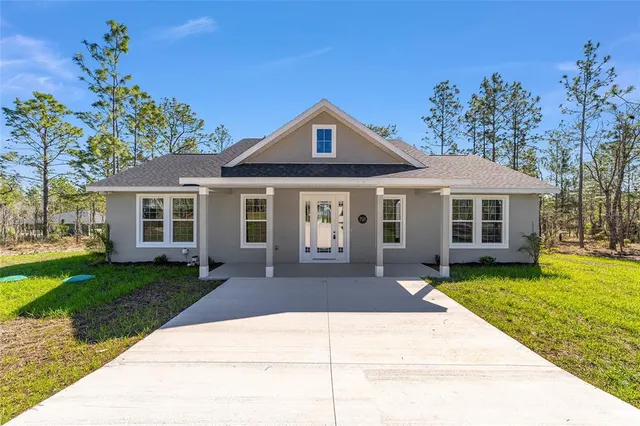 a front view of a house with a garden and porch