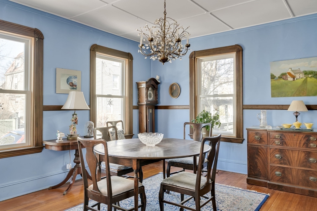32 Locke Street Cambridge, MA 02140 - Photo 12 of 32 a dining room with furniture a large window and wooden floor