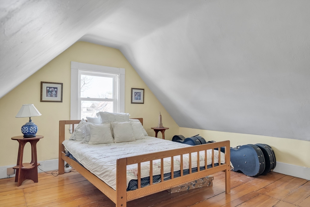 32 Locke Street Cambridge, MA 02140 - Photo 22 of 32 a bedroom with a bed and wooden floor