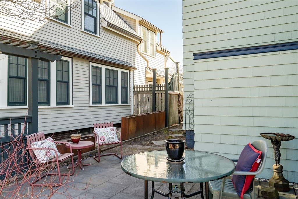 32 Locke Street Cambridge, MA 02140 - Photo 26 of 32 a backyard of a house with table and chairs