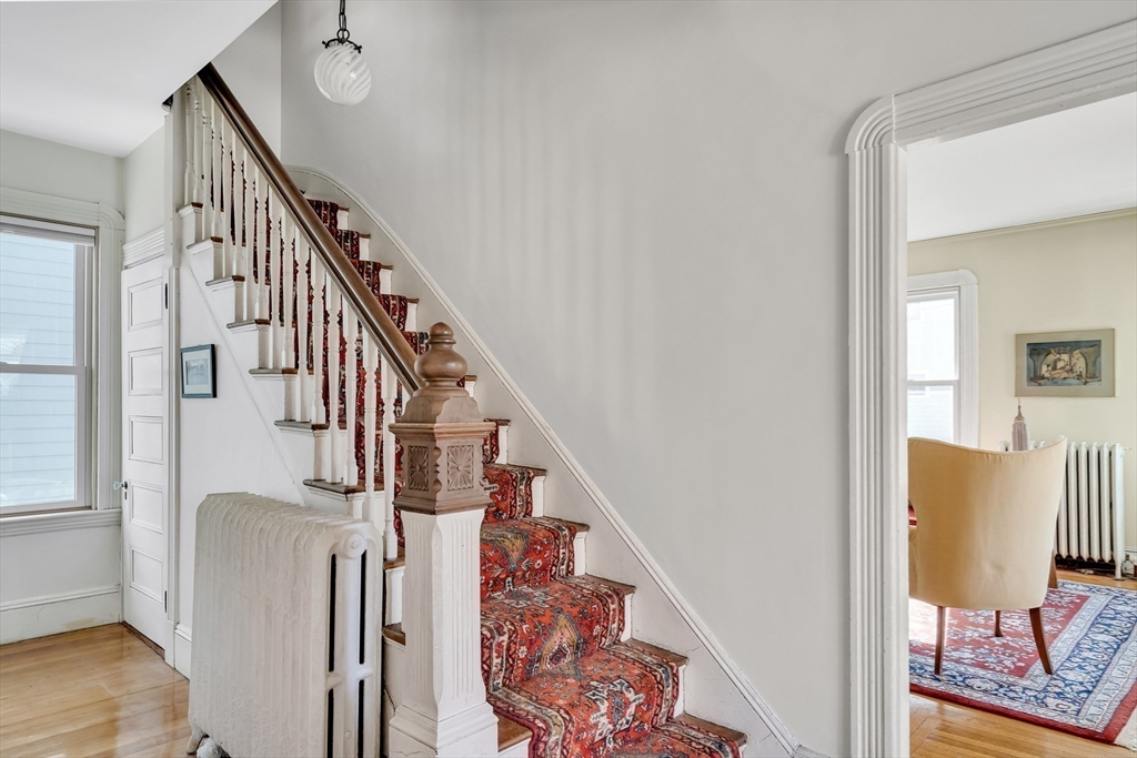 32 Locke Street Cambridge, MA 02140 - Photo 7 of 32 a view of entryway with wooden floor and stairs
