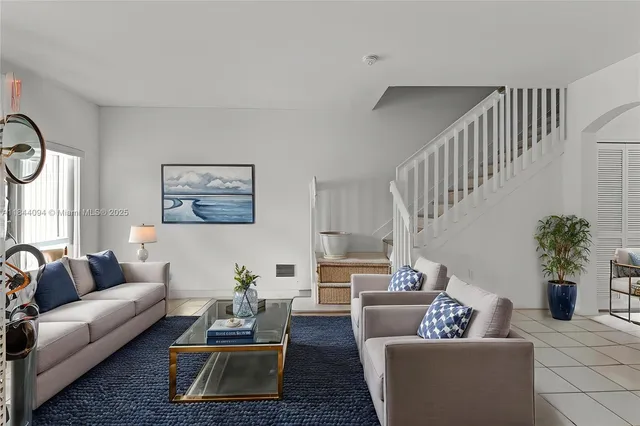 a living room with furniture potted plant and a window