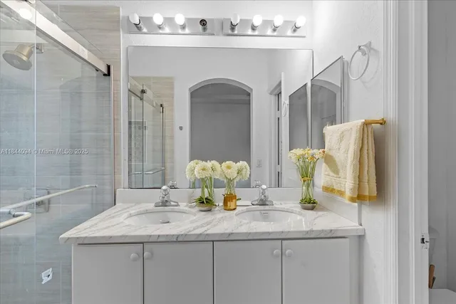 a bathroom with a granite countertop sink a toilet and a mirror