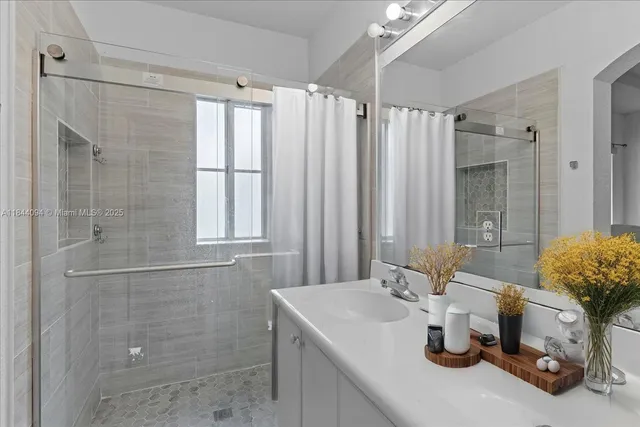 a bathroom with a double vanity sink and a large mirror