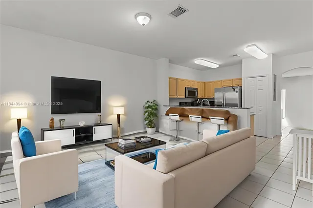 a living room with furniture and a flat screen tv