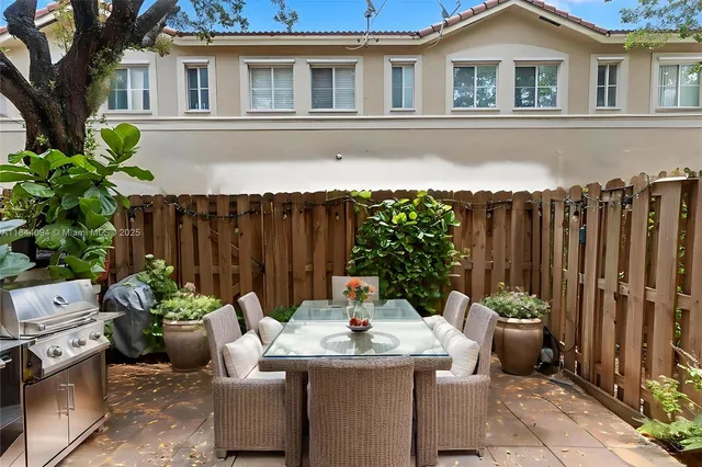 a backyard of a house with table and chairs