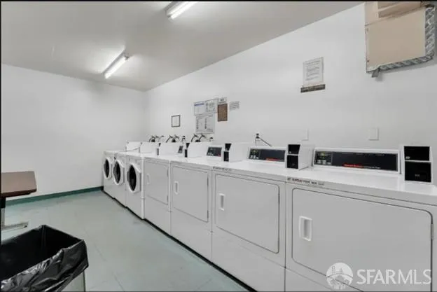 a utility room with sink dryer and washer