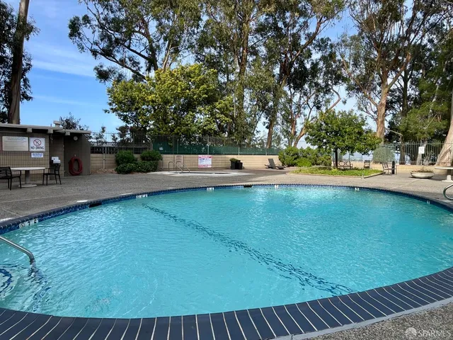 a view of a swimming pool with a yard