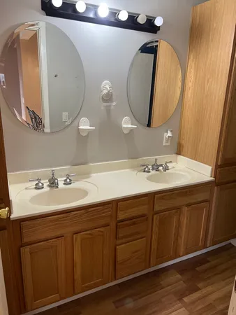a bathroom with a double vanity sink and a mirror