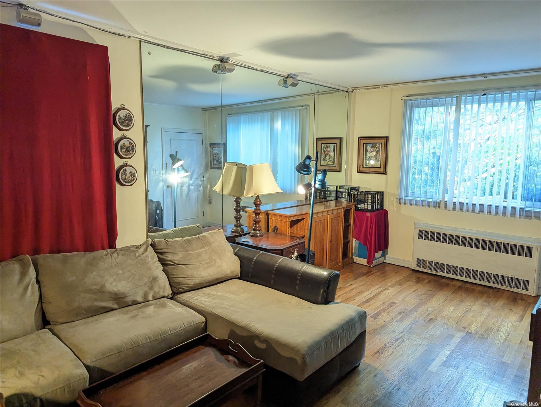 Undisclosed Address Queens, NY 11365 - Photo 2 of 18 a living room with furniture and a window