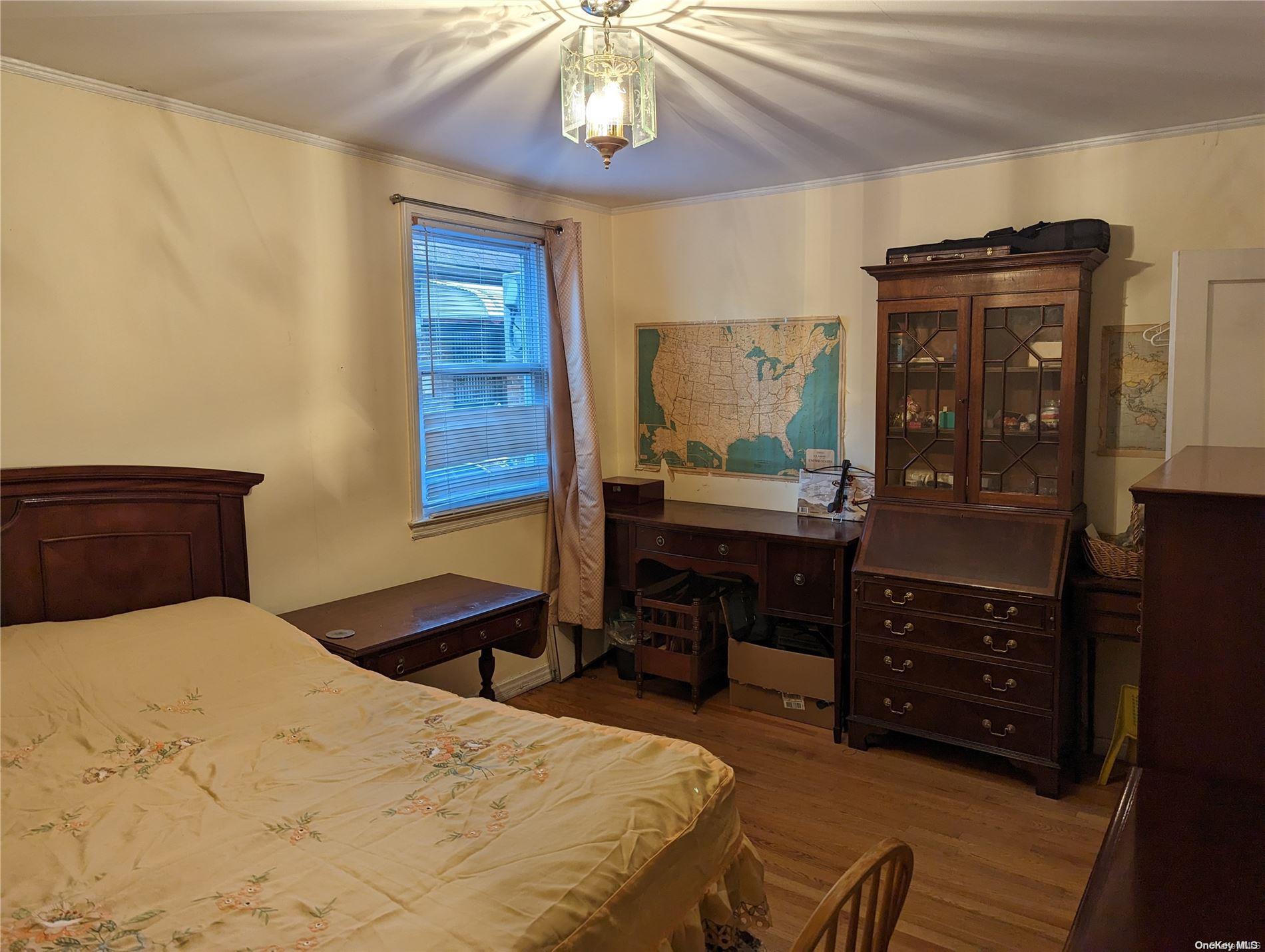 Undisclosed Address Queens, NY 11365 - Photo 7 of 18 a bedroom with a bed and a dresser