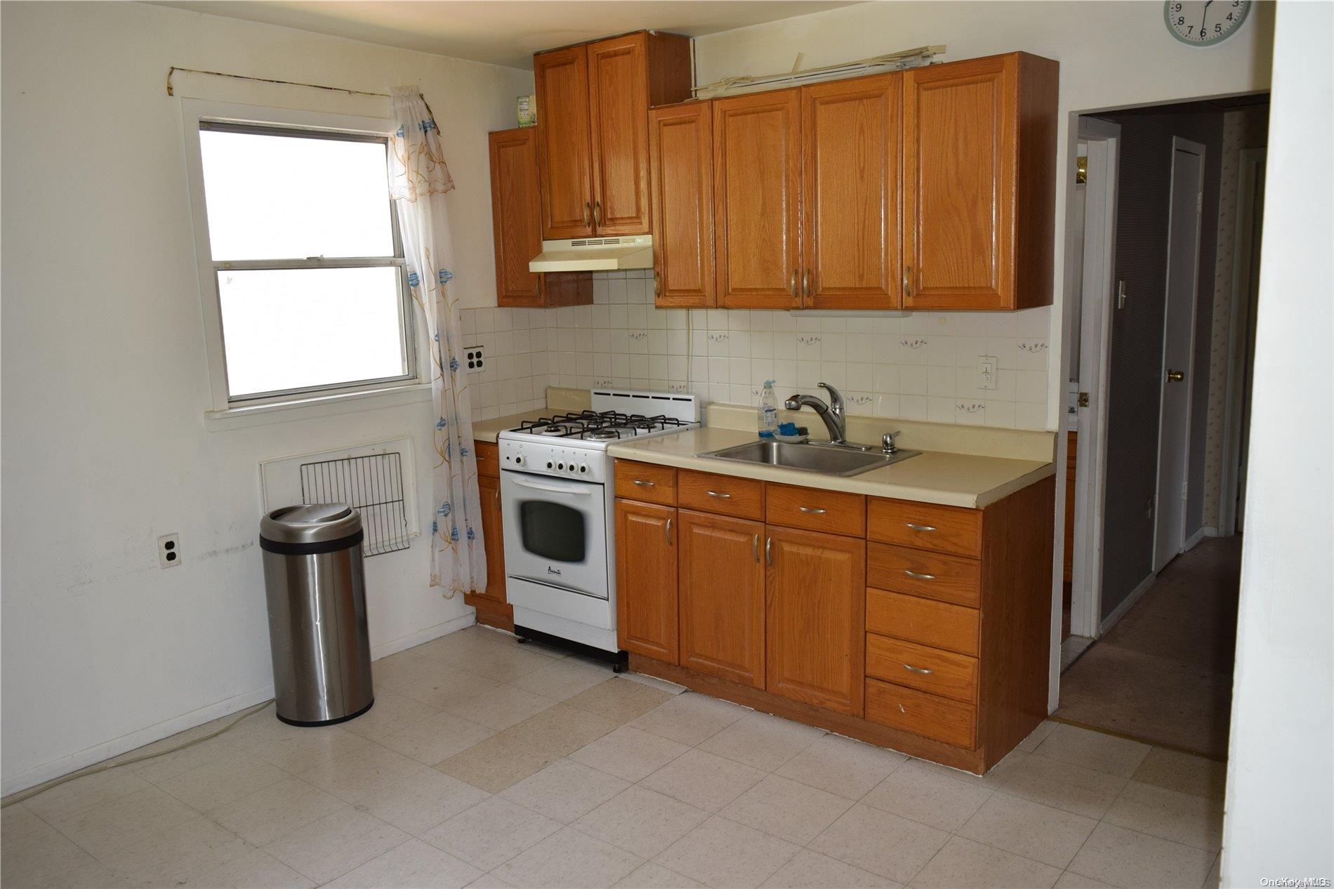 Undisclosed Address Queens, NY 11365 - Photo 8 of 18 a kitchen with sink a stove and cabinets