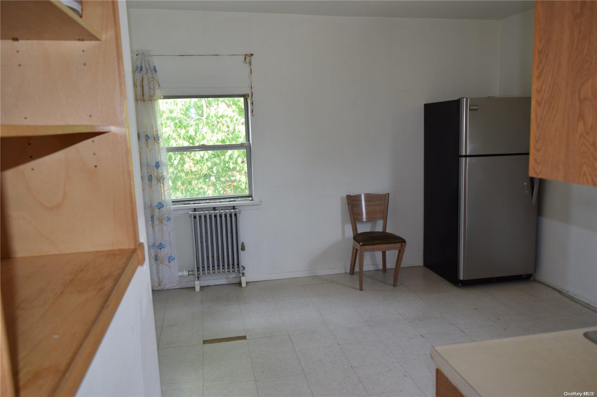 Undisclosed Address Queens, NY 11365 - Photo 9 of 18 a view of a livingroom with furniture and a refrigerator