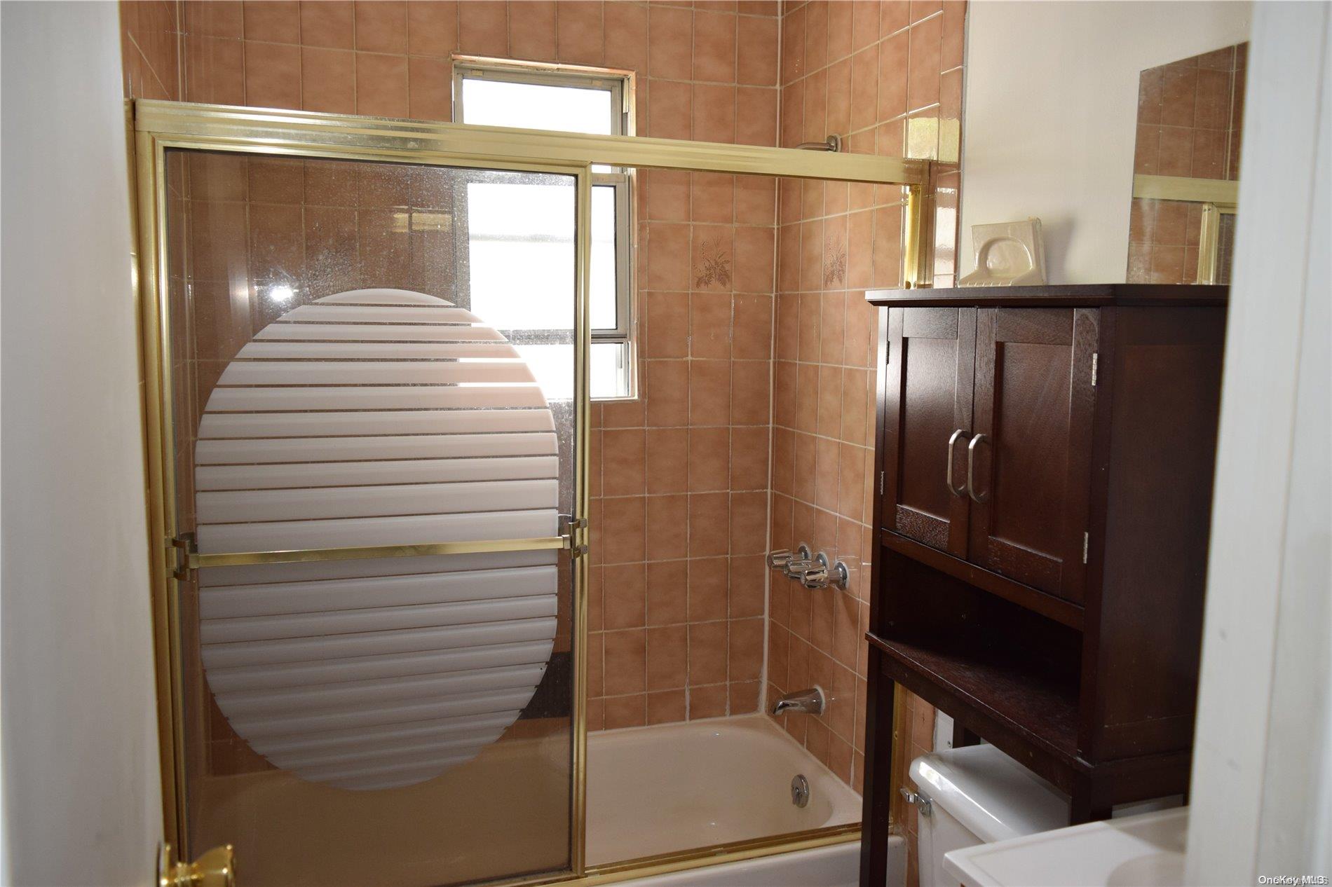 Undisclosed Address Queens, NY 11365 - Photo 10 of 18 a bathroom with a shower