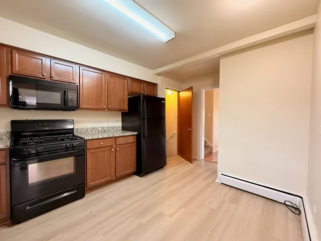 a kitchen with stainless steel appliances granite countertop a refrigerator stove and sink