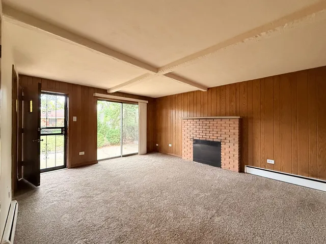 an empty room with furniture and a fireplace