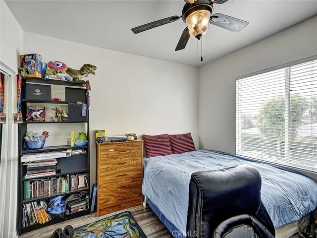 a bedroom with a bed and a book shelf
