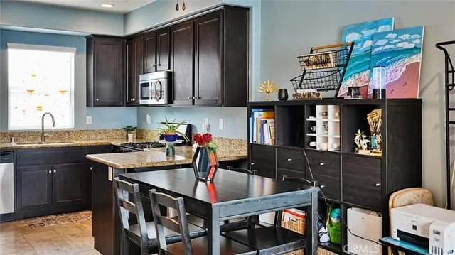 a kitchen with stainless steel appliances granite countertop a sink counter space and a window