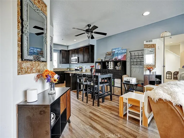 a view of a dining room with furniture a chandelier and wooden floor