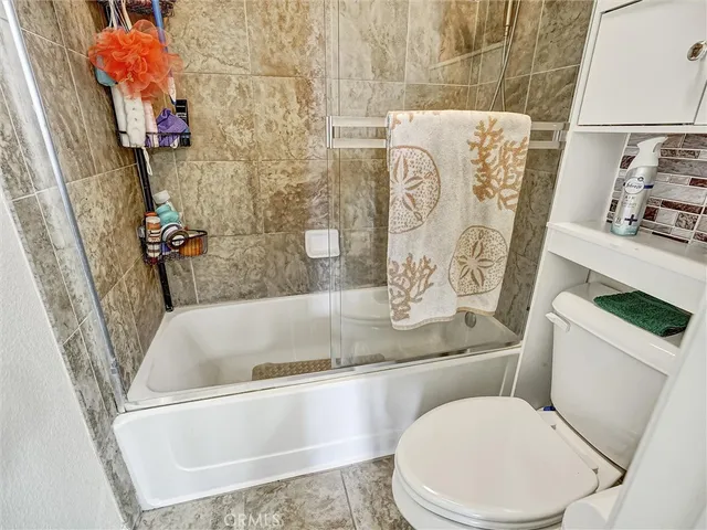 a white bath tub sitting next to a white toilet and sink