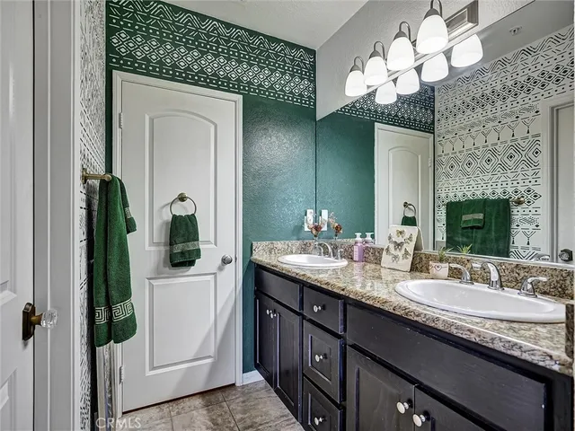a bathroom with a sink vanity and a mirror