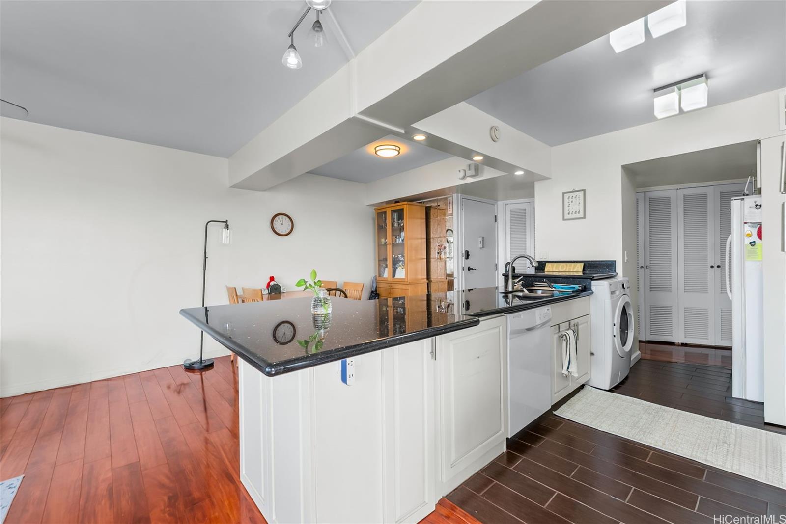 1022 Prospect Street, Unit 902B Honolulu, HI 96813 - Photo 7 of 25 a kitchen with stainless steel appliances granite countertop a sink and wooden floors