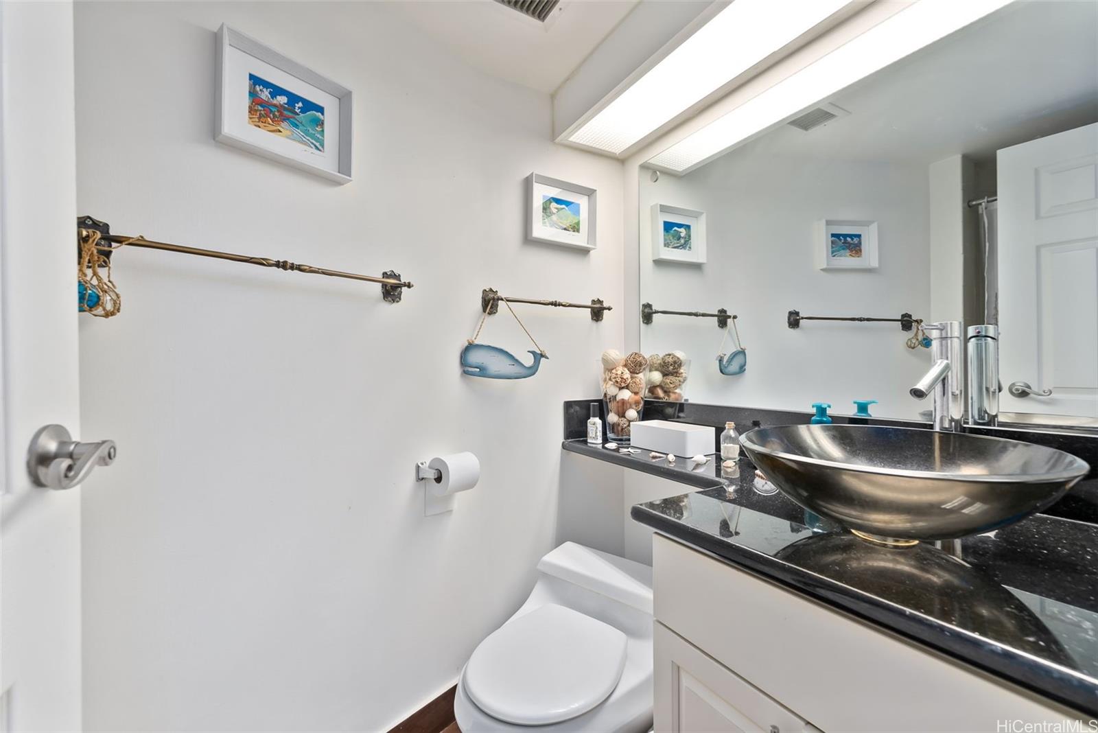 1022 Prospect Street, Unit 902B Honolulu, HI 96813 - Photo 10 of 25 a bathroom with a toilet sink and mirror