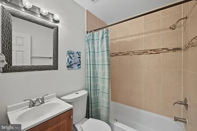 a bathroom with a sink mirror toilet and shower