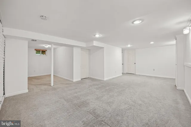 a view of an empty room and a bathroom
