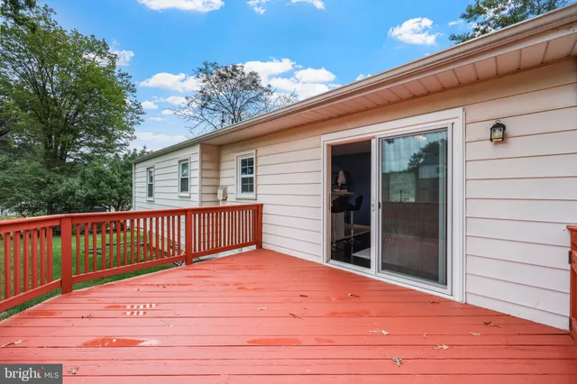 a view of deck with wooden floor and fence and floor to ceiling window
