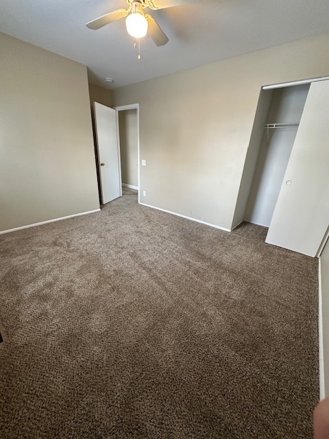 209 Andover Court Bolingbrook, IL 60440 - Photo 12 of 14 an empty room with a ceiling fan and carpet