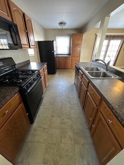 209 Andover Court Bolingbrook, IL 60440 - Photo 3 of 14 a kitchen with stainless steel appliances granite countertop a stove a sink and a refrigerator