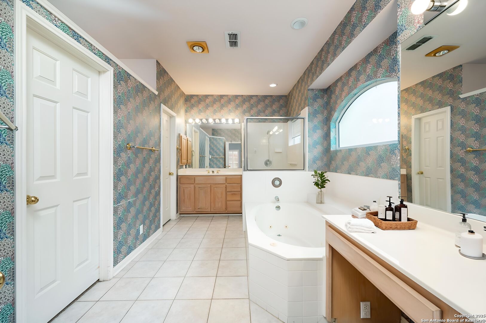 3911 Heights Way San Antonio, TX 78230 - Photo 12 of 22 a large bathroom with a double vanity sink a mirror and a shower