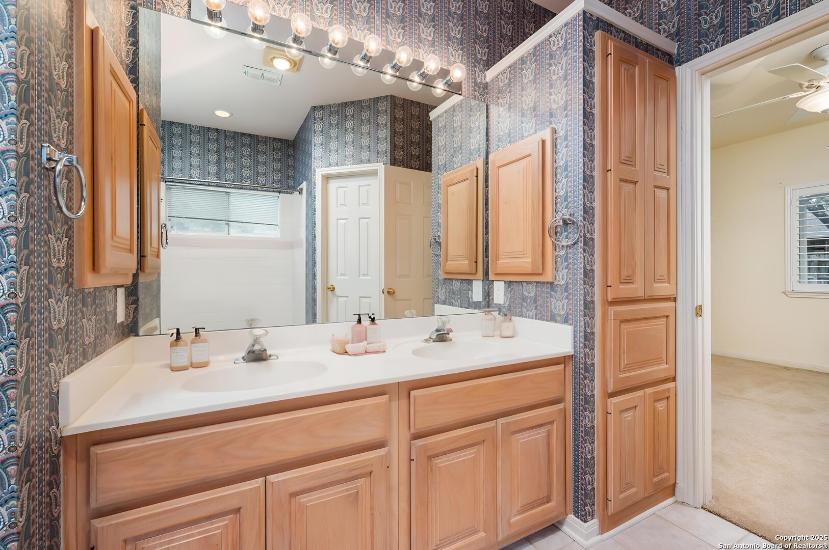 3911 Heights Way San Antonio, TX 78230 - Photo 15 of 22 a bathroom with a sink double vanity and a mirror